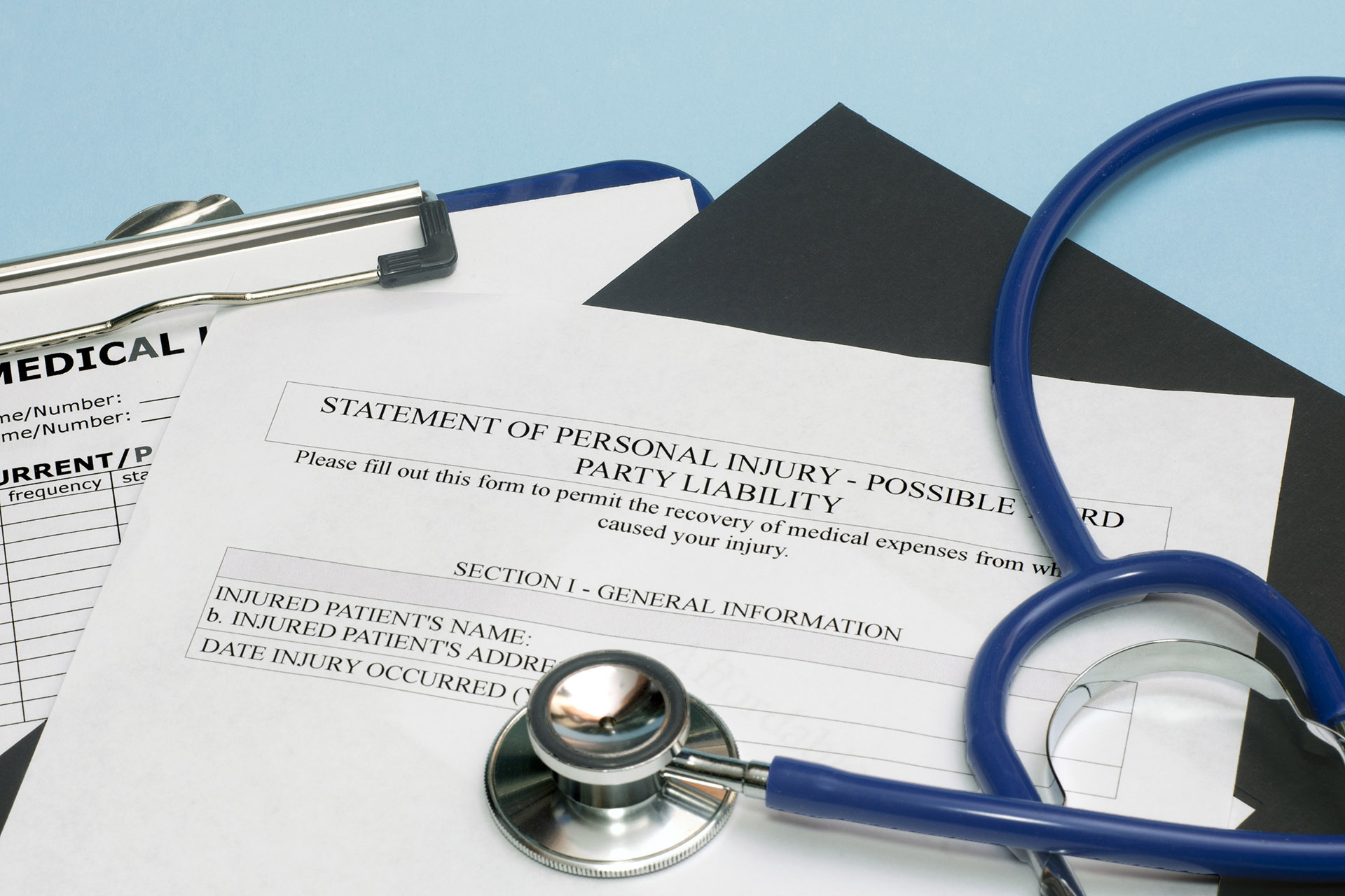 Statement of personal injury form with patient chart and stethoscope.