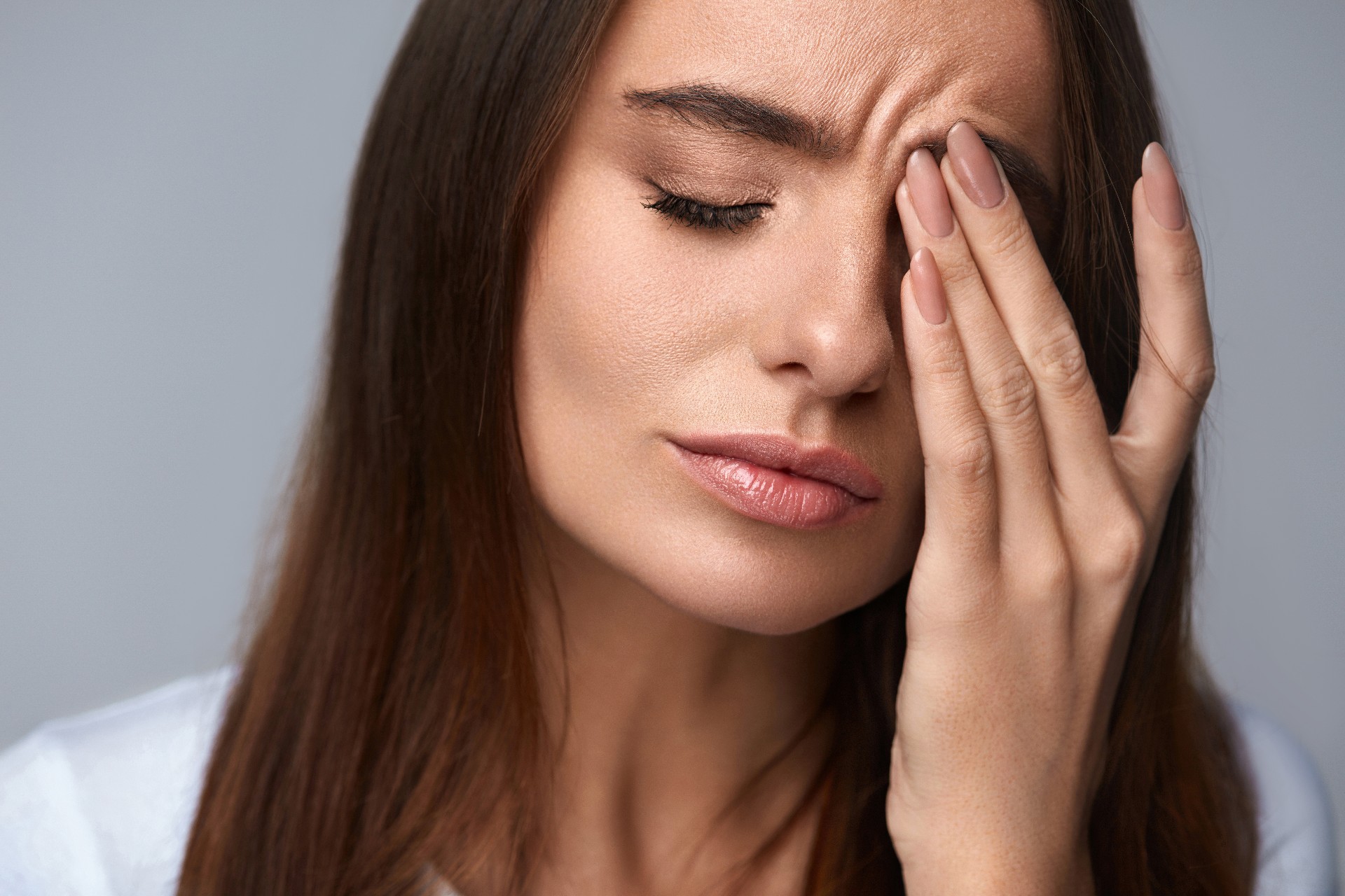 Pain. Tired Exhausted Stressed Woman Suffering From Strong Eye Pain. Portrait Of Beautiful Young Female Feeling Sick, Having Headache, Nose Pain And Touching Painful Eyes. Healthcare. High Resolution